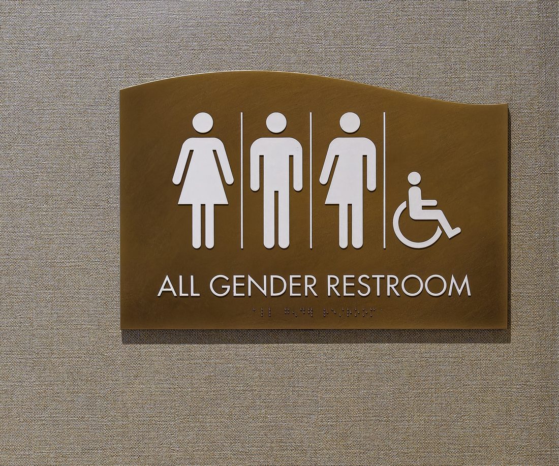 ADA-compliant tactile and braille restroom sign