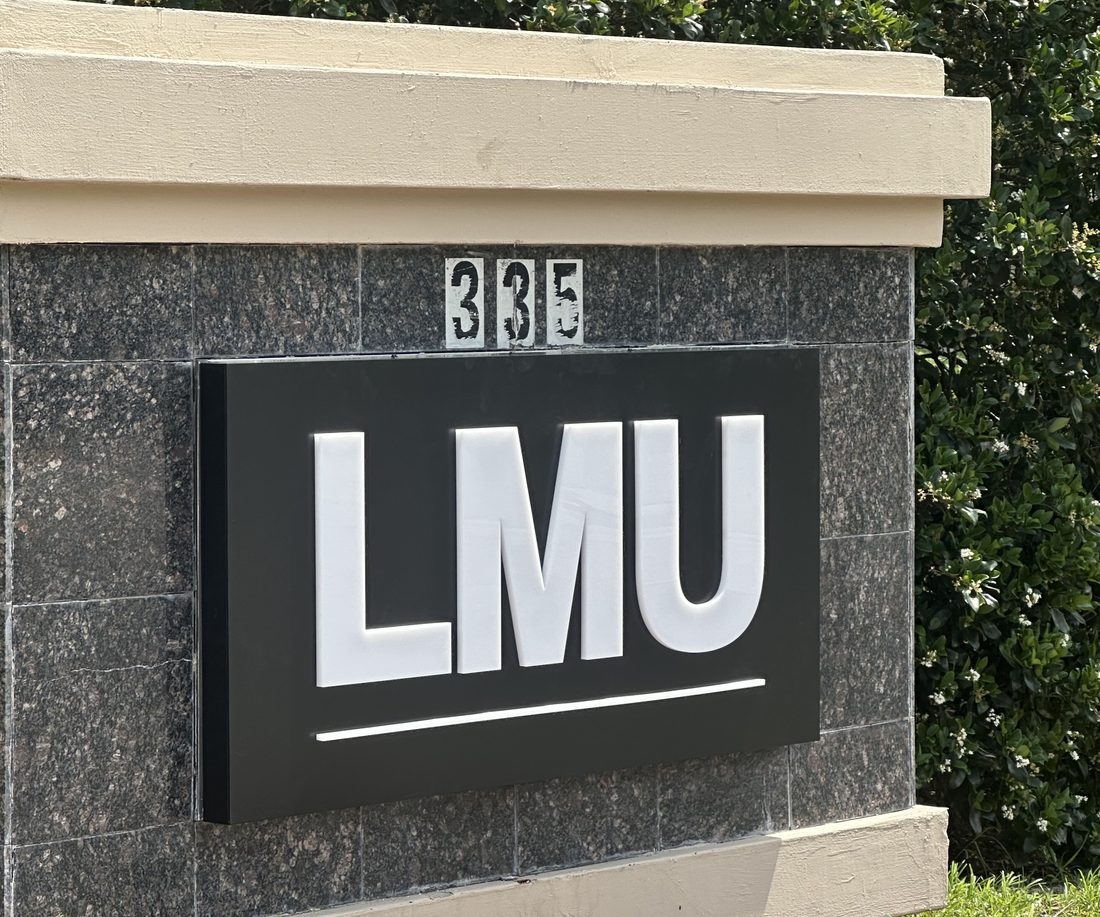 Stone monument sign with dimensional lettering